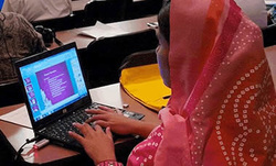A teacher working on a laptop