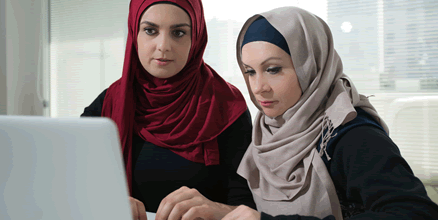 Two teachers at a laptop